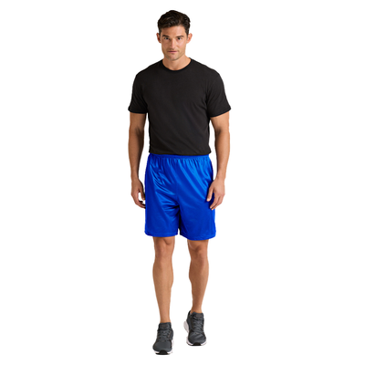 man standing at an angle in a tan shortsleeve tshirt and blue mesh shorts 060M