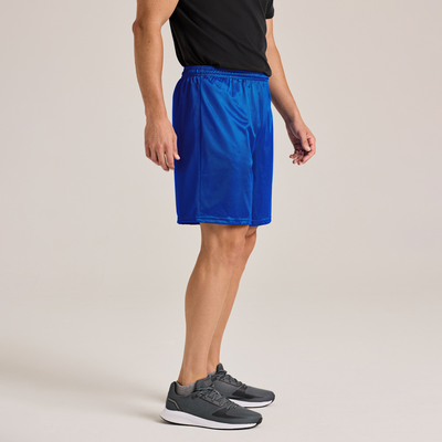 man standing sideways in a shortsleeve tshirt and blue mesh shorts 060M