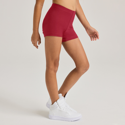 girl facing sideways wearing red compression shorts
