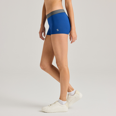 woman facing side wearing blue sports bra and compression short 1110V