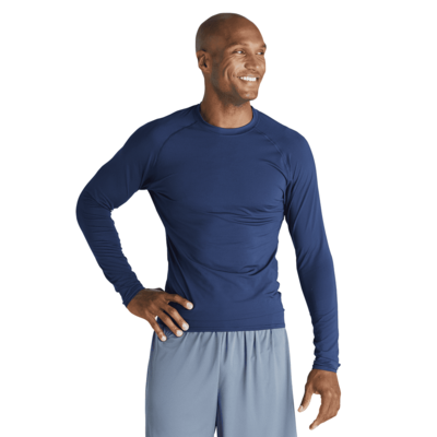 man facing front wearing a navy blue long sleeve compression top and grey shorts