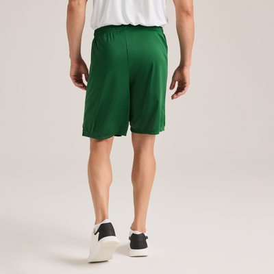 man facing backward wearing a white short sleeve t shirt and green shorts 1540M