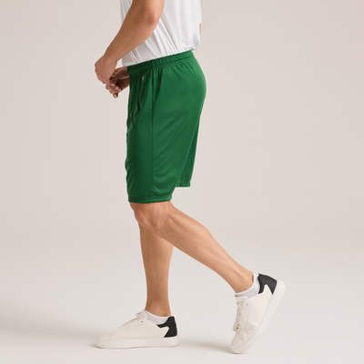 man facing side wearing a white short sleeve t shirt and green shorts 1540M