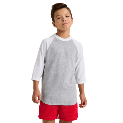 boy facing front wearing a grey and white baseball t shirt and red shorts 210B
