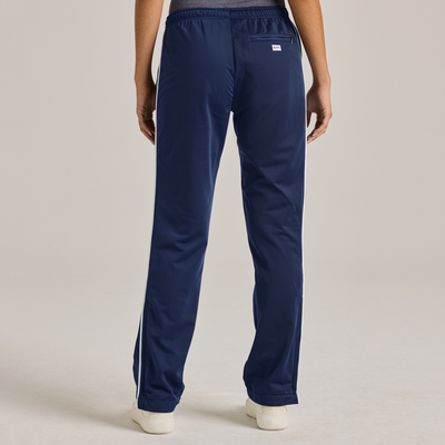 woman facing back wearing royal blue warm up pants with white piping on the legs 3245V