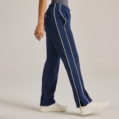 woman facing side wearing royal blue warm up pants with white piping on the legs 3245V