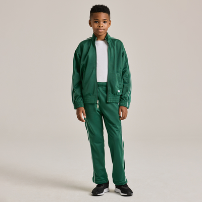 boy wearing green warm up pants with white stripes 3245Y