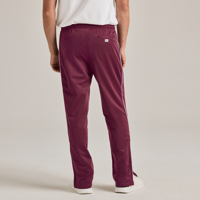 man facing backward wearing maroon and white stripe warm up pants 3245