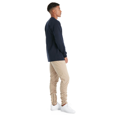 man standing sideways wearing delta apparel style 61750 long sleeve tee shirt in athletic navy