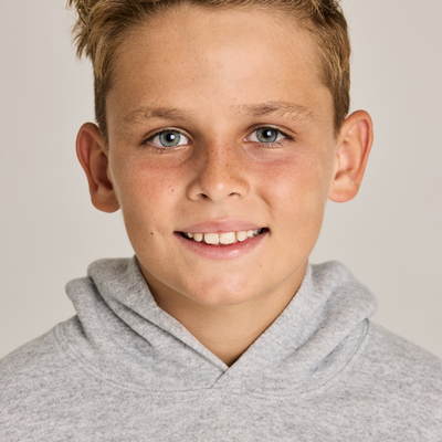 boy facing forward wearing a grey youth classic hooded sweatshirt B9289 closeup