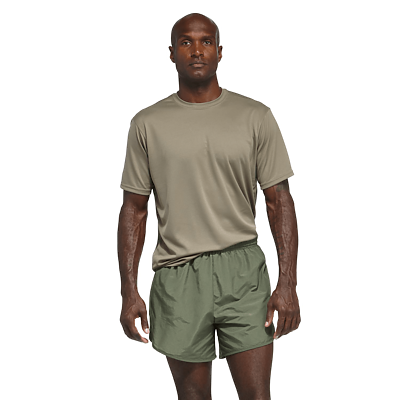 man wearing a tan short sleeve shirt and od green running shorts