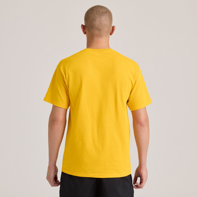 man facing front wearing a yellow midweight short sleeve shirt and black jersey shorts M305 back view