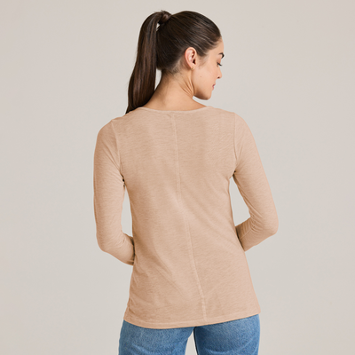 woman facing angled forward wearing a triblend scoop neck longsleeve tee and jeans P507T
