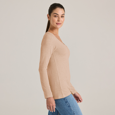 woman facing side wearing a triblend scoop neck longsleeve tee and jeans P507T