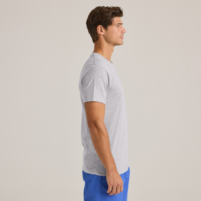man looking to the left wearing  grey short sleeve crew neck platinum shirt and blue shorts - P601C