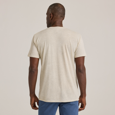 man facing backwards wearing Delta Platinum Adult Tri-Blend Short Sleeve V-Neck blank wholesale Tee in oatmeal heather color