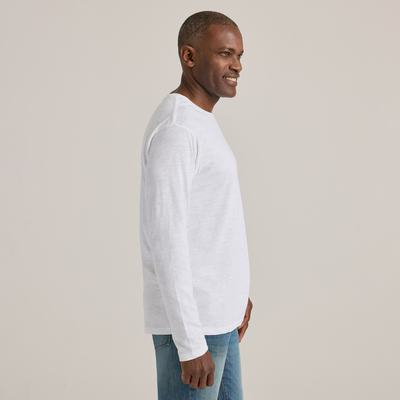 man facing to the side wearing Delta Platinum Adult Slub Long Sleeve Crew Neck blank wholesale Tee in white color