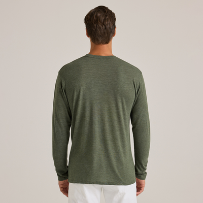 man facing back wearing Delta Platinum Adult Tri-Blend Long Sleeve Crew Neck wholesale blank Tee in green color