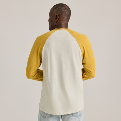 man facing back wearing Delta Platinum Men's Tri-Blend 3/4 Sleeve Raglan wholesale blank Tee white body yellow sleeves