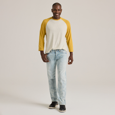 man facing front wearingDelta Platinum Men's Tri-Blend 3/4 Sleeve Raglan wholesale blank Tee white body yellow sleeves