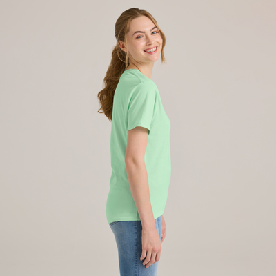 woman facing side wearing a key lime short sleeve crew neck platinum wholesale blank tee shirt P601