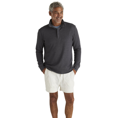 man angled to the right wearing an oatmeal quarter zip platinum pullover